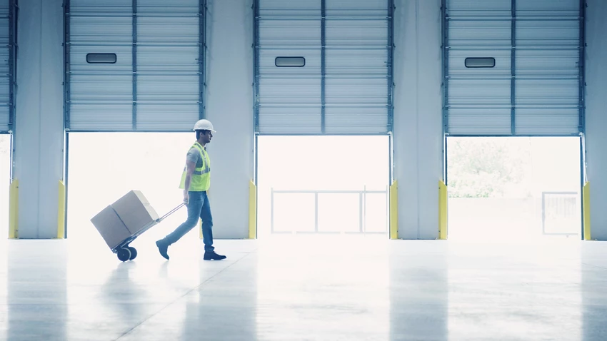 Worker pulling hand truck 