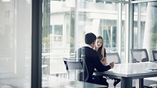 Coworkers in discussion in conference room