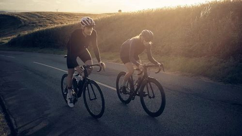 Two cyclists out cycling on a country road